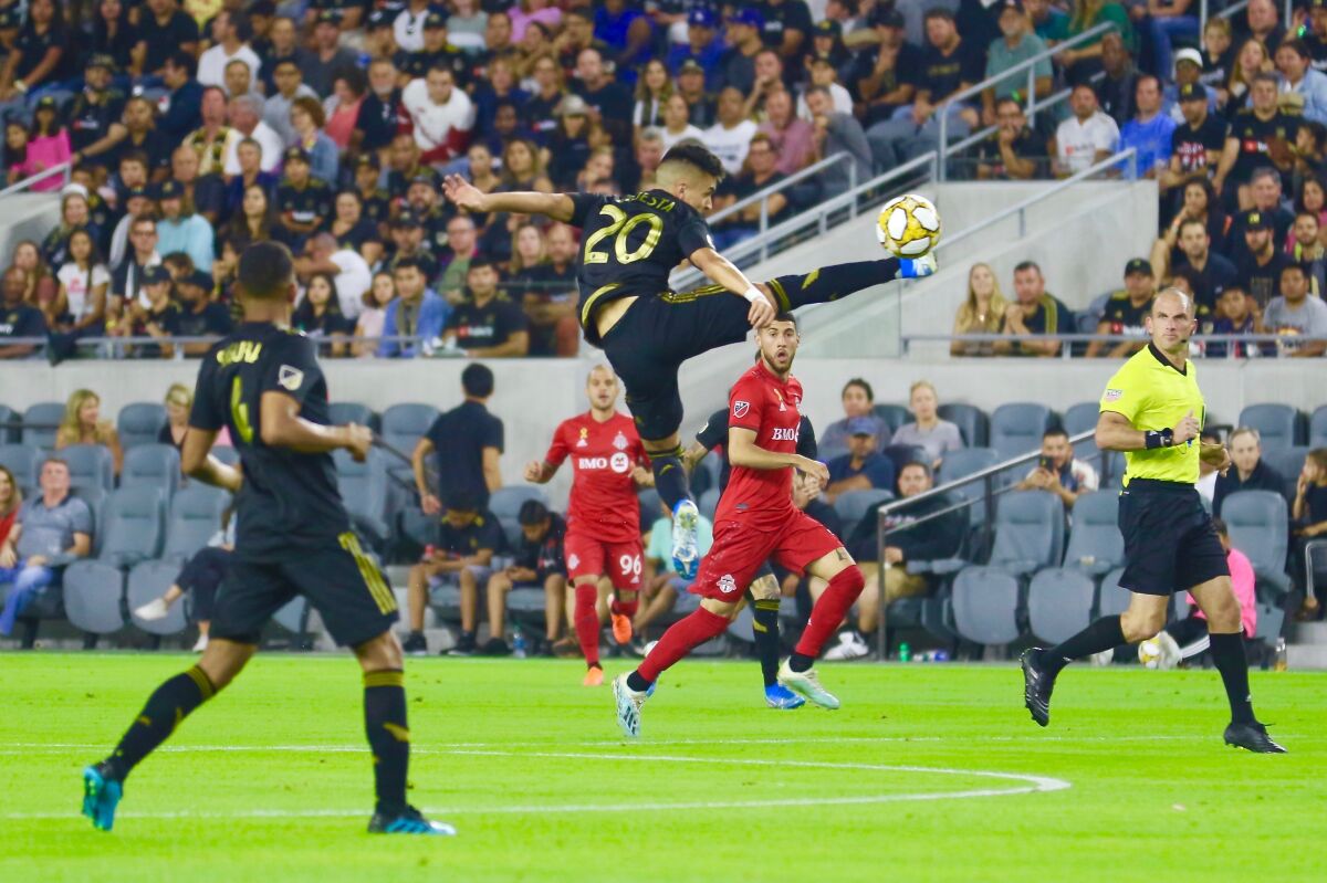 LAFC midfielder Eduardo Atuesta controls the ball in mid-air.