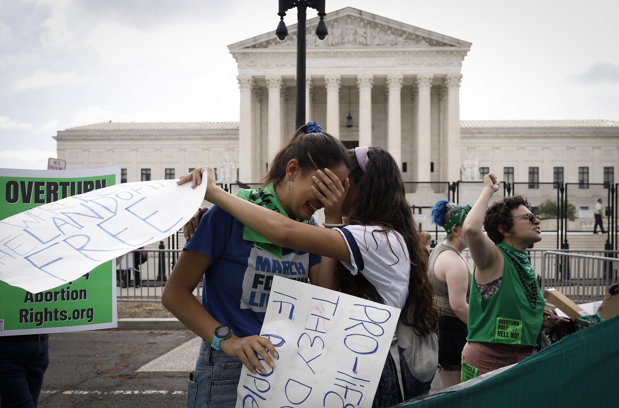 Abortion rights activists react in front of the U.S. Supreme Court.