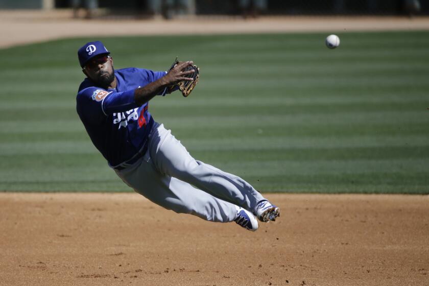 Dodgers third baseman Howie Kendrick throws to first after fielding a ball hit by the Chicago White Sox's Tyler Saladino during a spring training game in Phoenix on March 19.