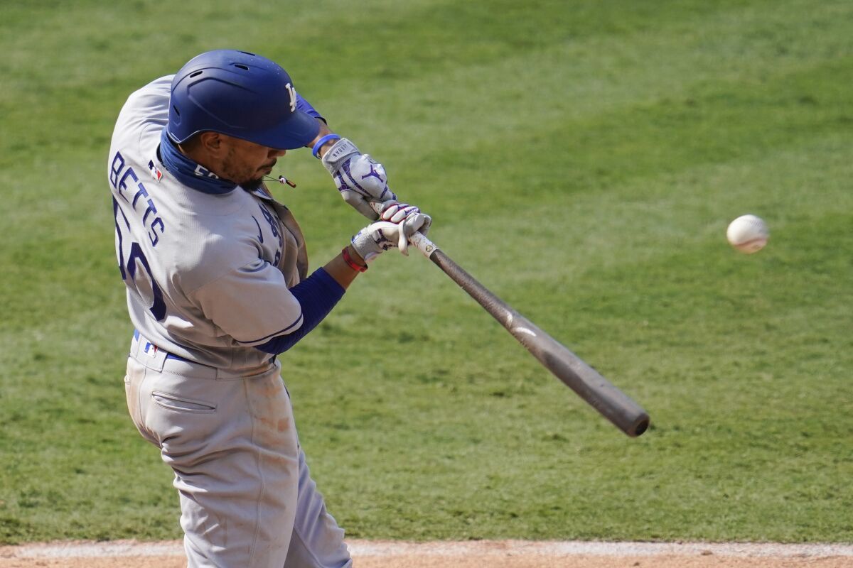 Dodgers right fielder Mookie Betts hits during an 8-3 win over the Angels.