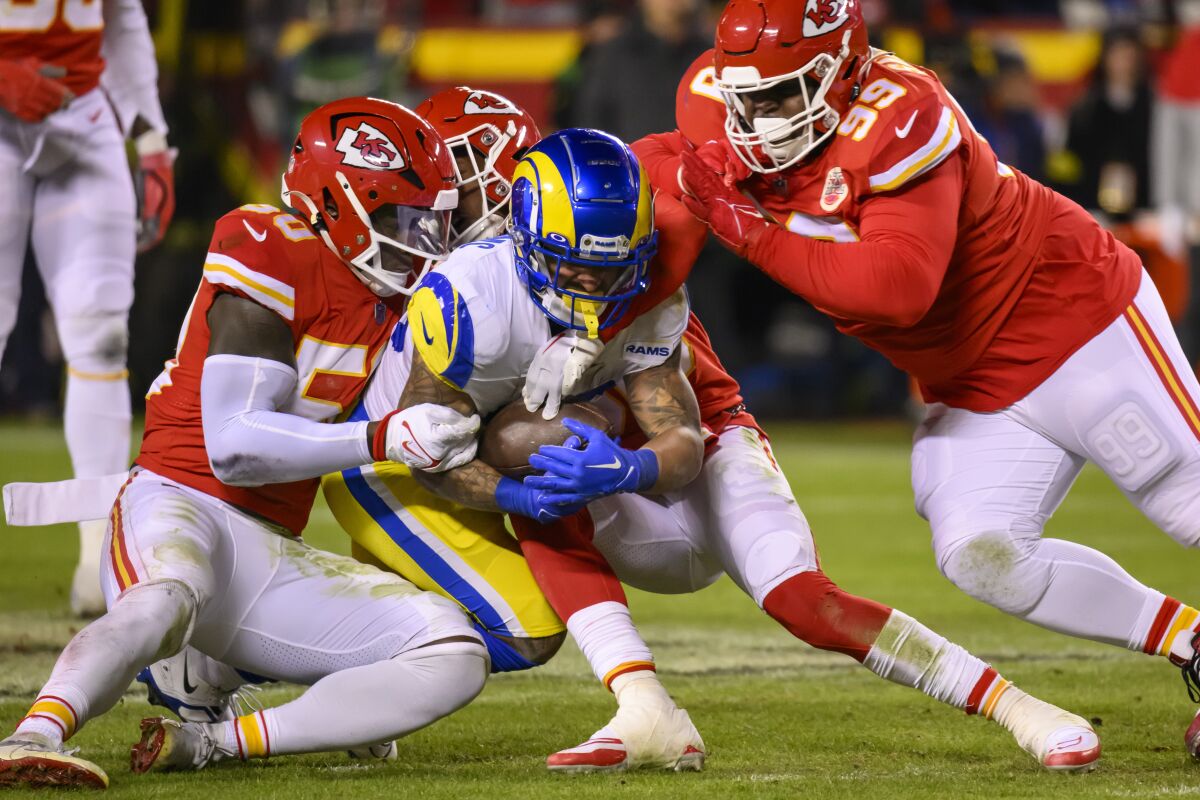 Kansas City Chiefs Khalen Saunders (99) and Willie Gay (50) tackle Rams running back Kyren Williams (23).