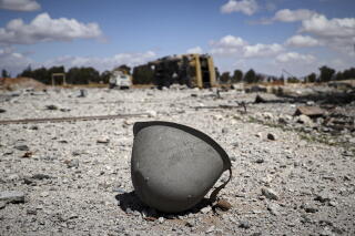 A helmet lies among the debris scattered at the site of an Israeli strike