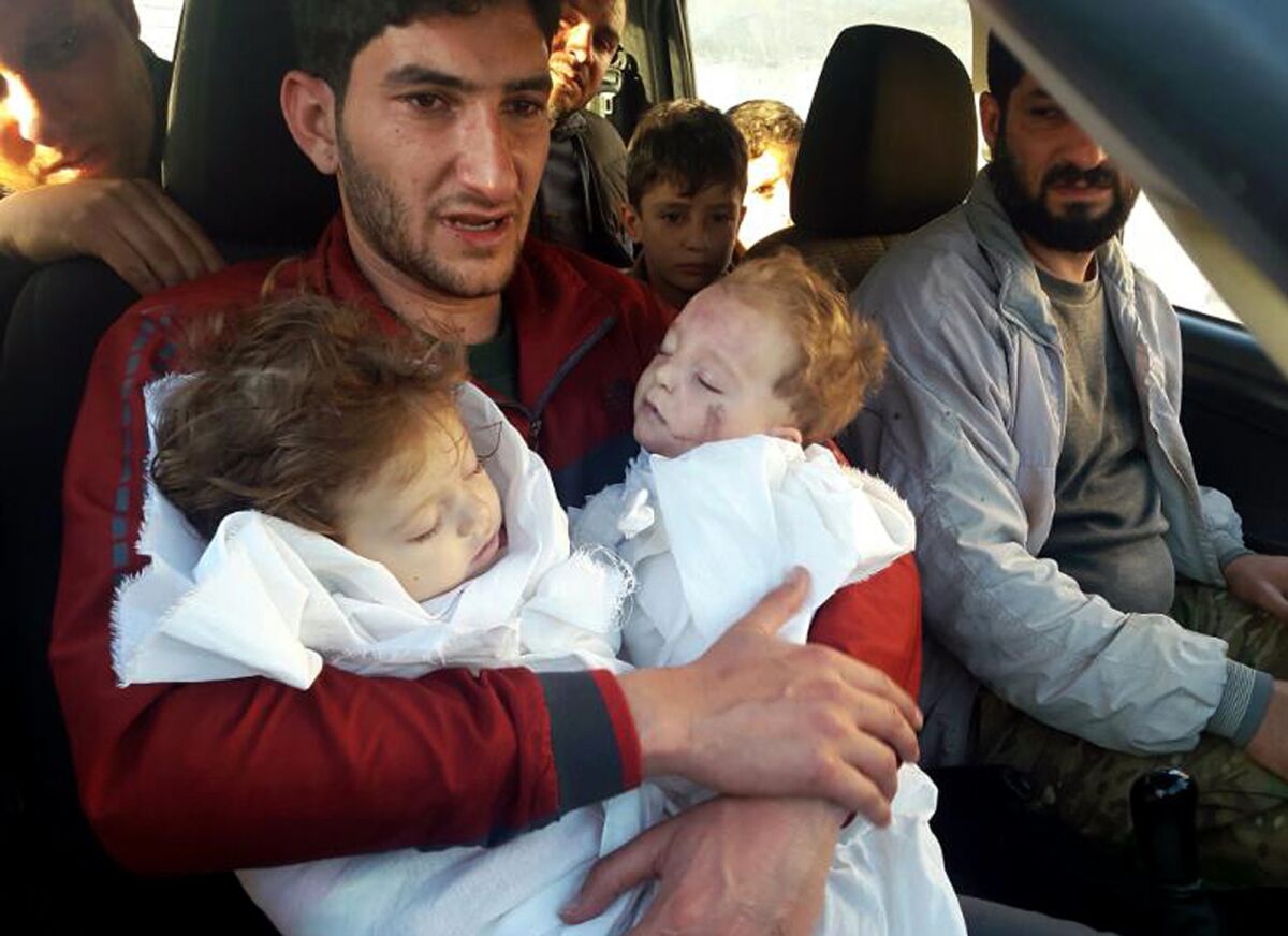 FILE - Abdel Hameed Alyousef, 29, holds his twin babies who were killed during a suspected chemical weapons attack, in Khan Sheikhoun in the northern province of Idlib, Syria, April 4, 2017. Legal and moral taboos were shattered with the use of chemical weapons during Syria's civil war. Hundreds were killed in poison gas attacks widely blamed on President Bashar Assad’s forces under the protection of his chief ally, Russian leader Vladimir Putin. Several years later, concerns are growing that such weapons could be used in Ukraine. (Alaa Alyousef via AP, File)
