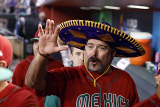 PHOENIX, ARIZONA - MARCH 15: Manager Benji Gil #30 of Team Mexico waves after Mexico defeated Team Canada.
