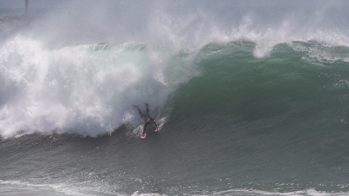 A body surfer slides down a big wave at the Wedge off Newport Beach in 2015. On Tuesday and Wednesday, surf generated by Hurricane Eugene off Mexico could reach as high as 10 feet along south-facing beaches in Orange County.