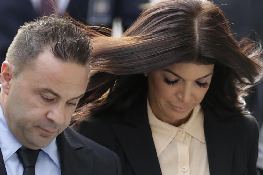"The Real Housewives of New Jersey" stars Giuseppe "Joe" Giudice, 43, and his wife, Teresa Giudice, 41, walk hand-in-hand toward the Newark, N.J., federal courthouse on Thursday.