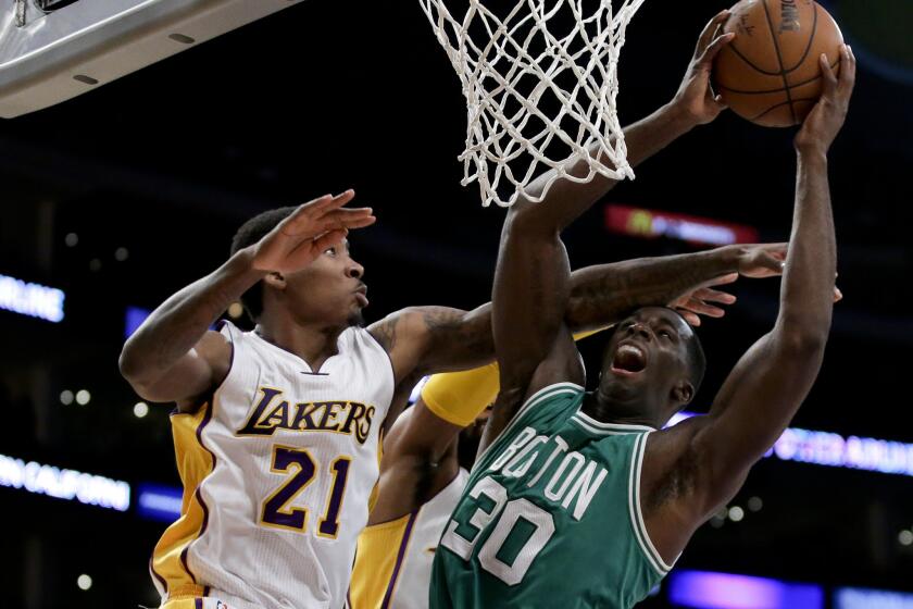 Celtics forward Brandon Bass tries to score inside against Lakers forward Ed Davis in February.