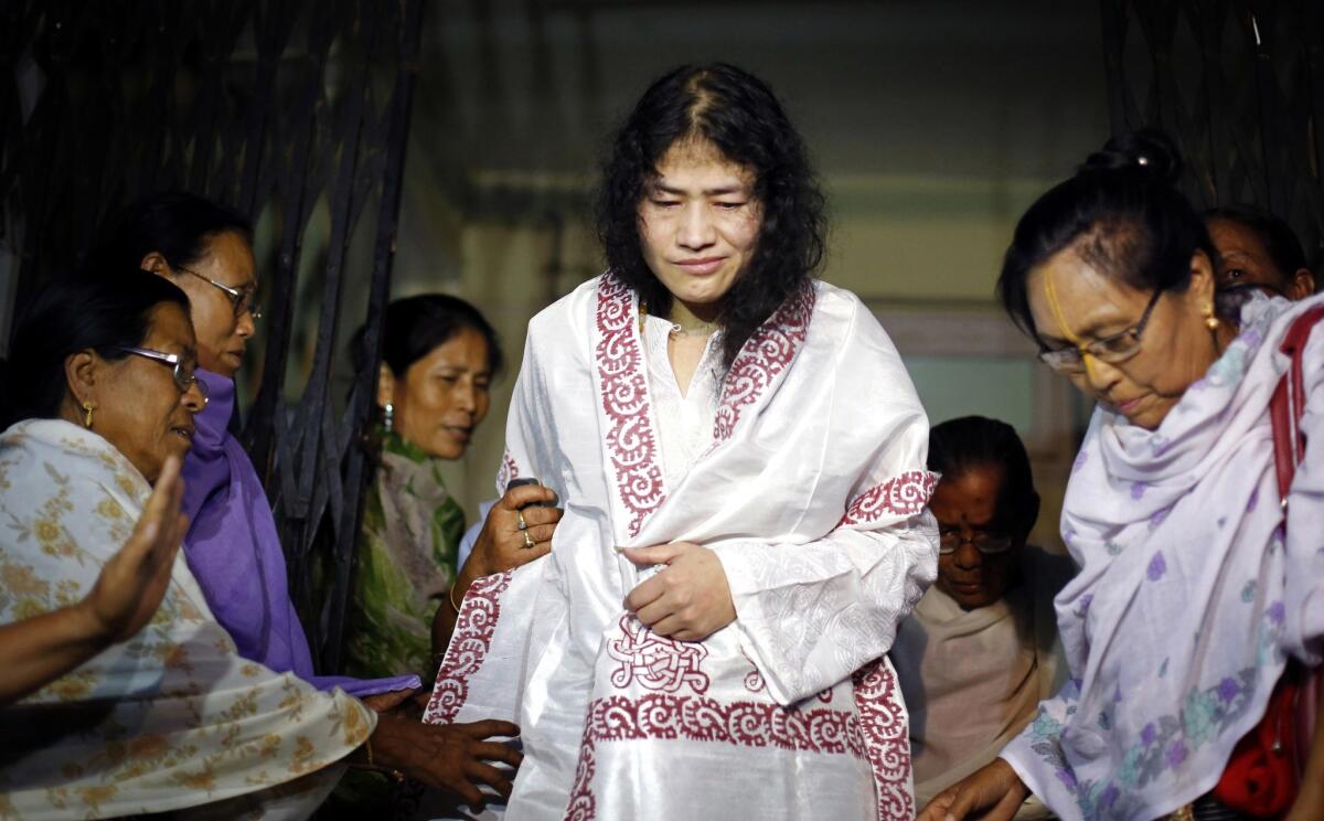 Indian rights activist Irom Sharmila, center, is greeted on Aug. 20 by supporters after her periodic release from a hospital jail in Imphal.