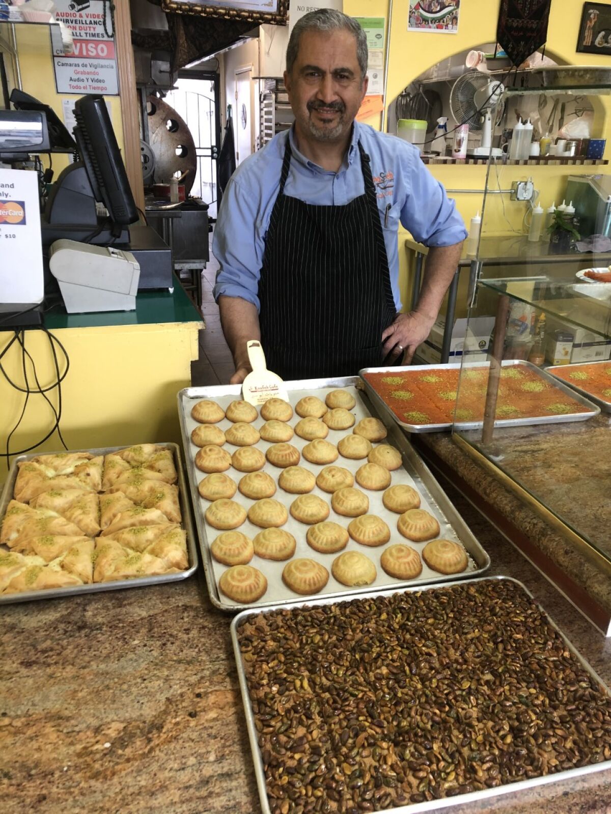 Asem Abusir, owner of Knafeh Cafe, usually has many large catering orders to fulfill during Ramadan. But this year he's offering smaller trays for individual families.