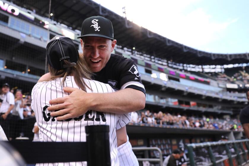 White Sox third baseman Todd Frazier gives a hug to a fan before game against the Los Angeles Dodgers at Guaranteed Rate Field on July 18, 2017. Frazier was traded to the New York Yankees after the game.