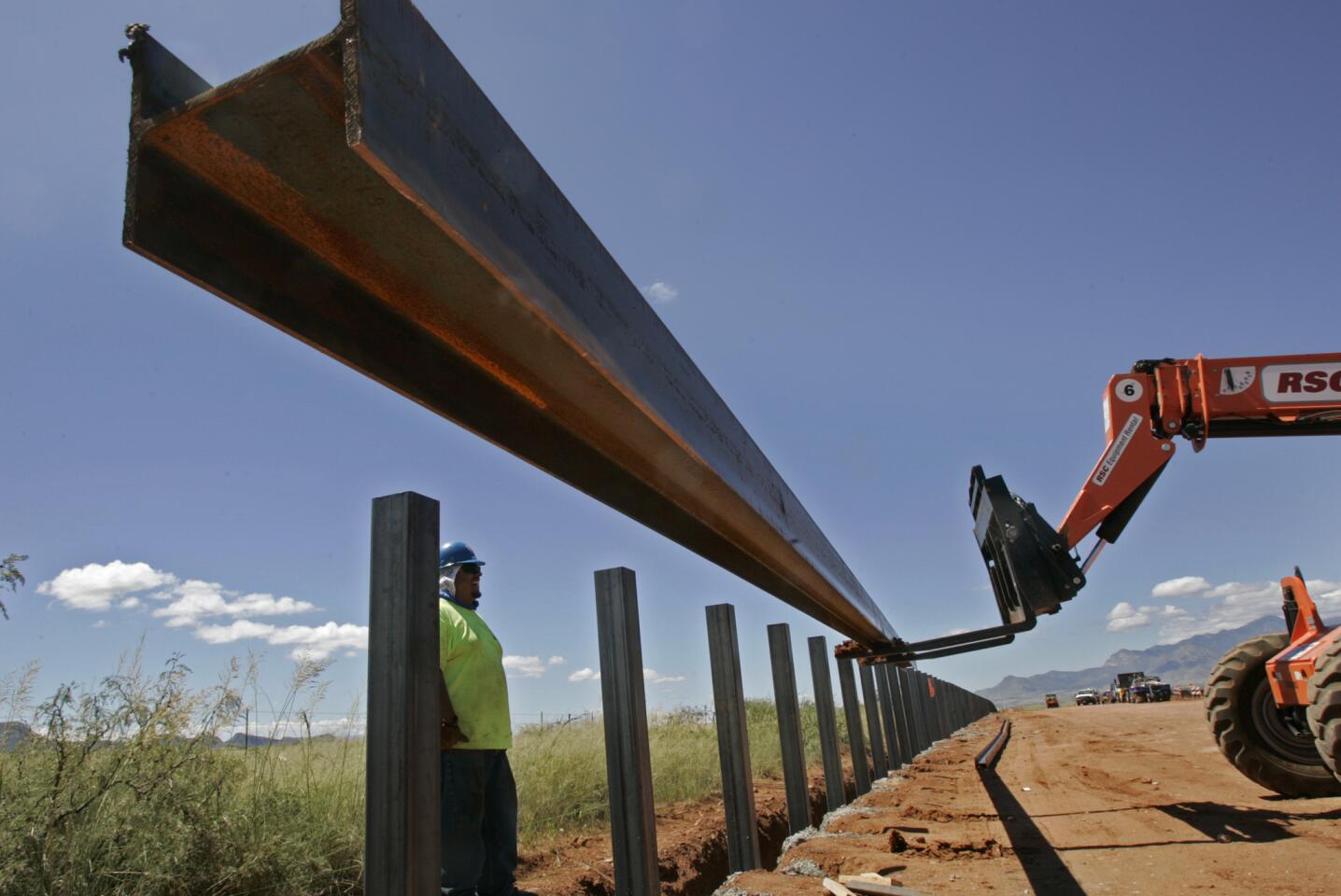 Sept. 11, 2007: A steel rail is lifted into position on the new U.S.-Mexico border fence outside of Naco, Ariz.