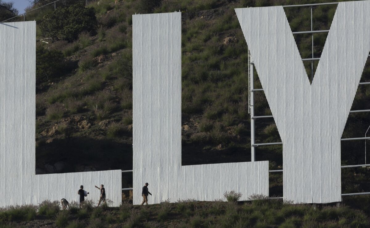 Workers next to the Hollywood sign