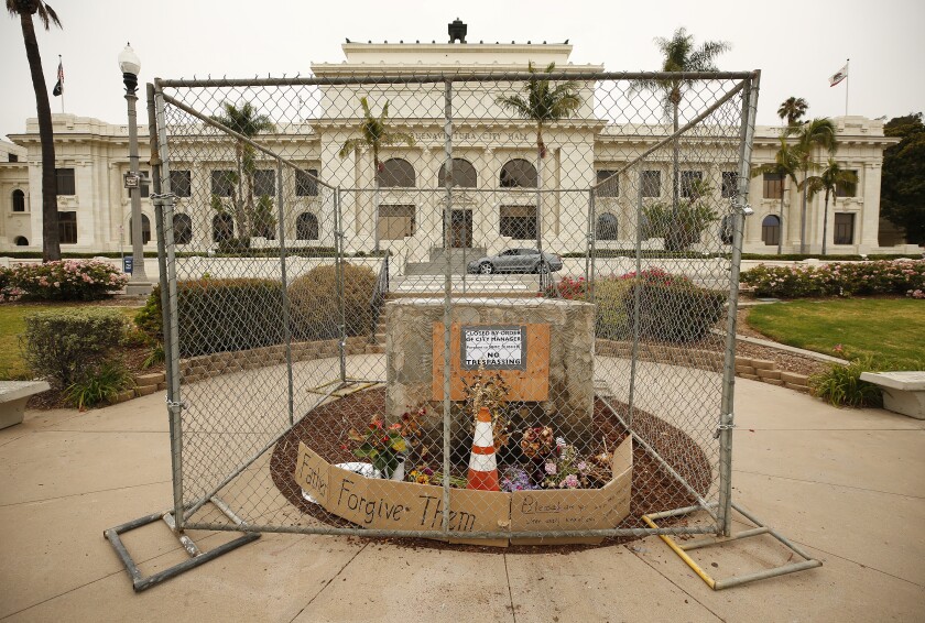 A stand that held a statue of Junipero Serra before it was removed in 2020 is protected by fencing at Ventura City Hall