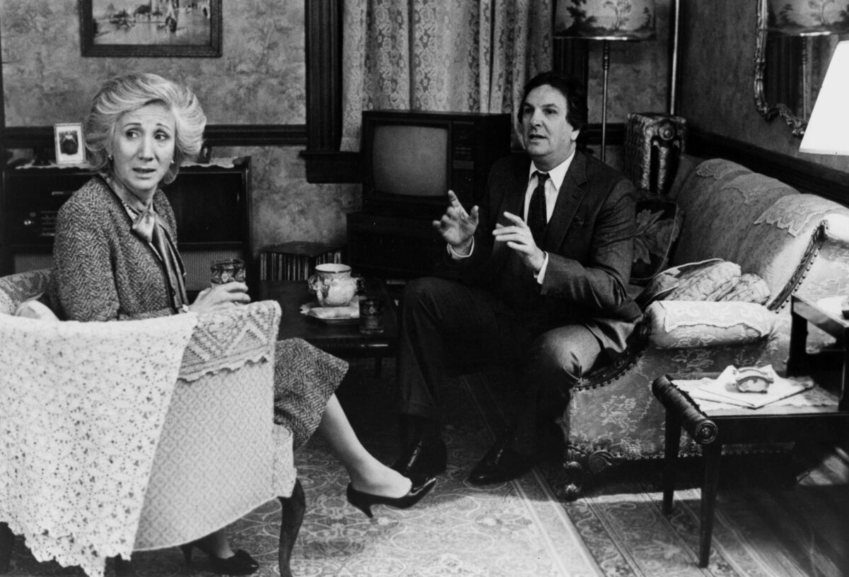 Olympia Dukakis and Danny Aiello sit in a living room in a scene from 1987's "Moonstruck."