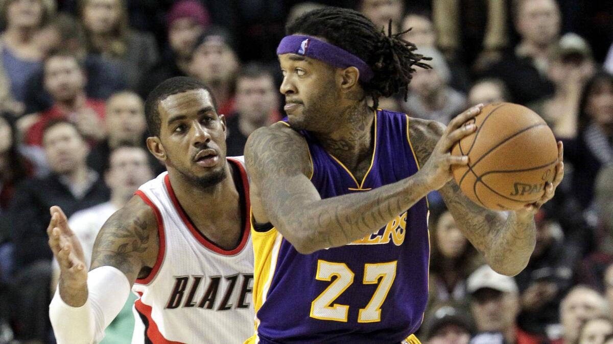 Lakers forward Jordan Hill looks to pass while being guarded by Portland Trail Blazers forward LaMarcus Aldridge during the Lakers' 98-94 loss on Jan. 5.