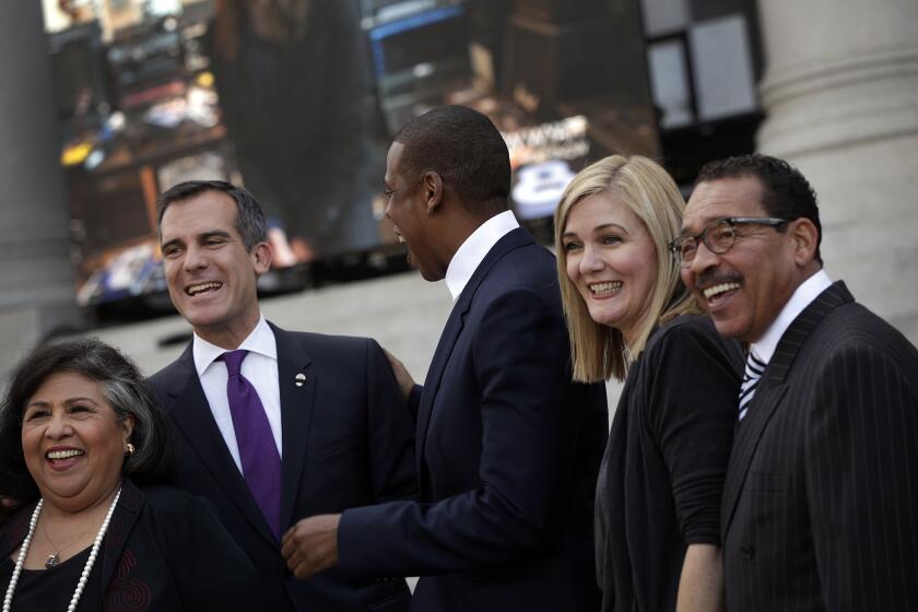 County Supervisor Gloria Molina, from left, Los Angles mayor Eric Garcetti, Jay Z, United Way President and CEO Elise Buik and Council President Herb Wesson on the steps of City Hall after a press conference to announce the inaugural L.A. edition of Jay Z's Budweiser Made In America festival.