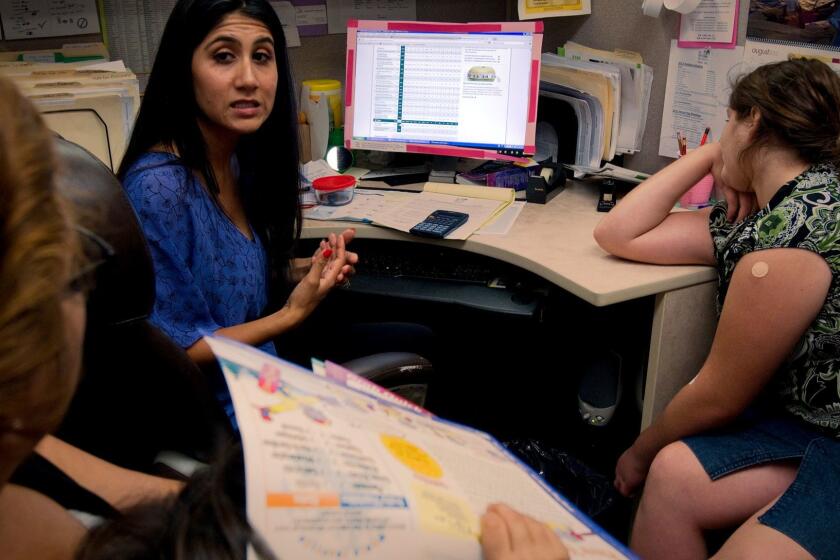 LOS ANGELES, CA - AUGUST 8, 2012: Nutritionist Gabrielle Guzman talks to Angelica Fortunato about her daughter Galexia Jone's,right, eating habits at T.H.E. Clinic. The 11-year-old is 60 pounds overweight and heading down a path towards diabetes if her eating habits don't change. One in eight Californians have Type 2 diabetes, which is mostly caused by obesity and poor diet.(Gina Ferazzi / Los Angeles Times).