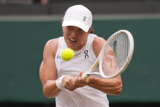 Iga Swiatek of Poland plays a backhand return to Yulia Putintseva of Kazakhstan during their third round match at the Wimbledon tennis championships in London, Saturday, July 6, 2024. (AP Photo/Alberto Pezzali)