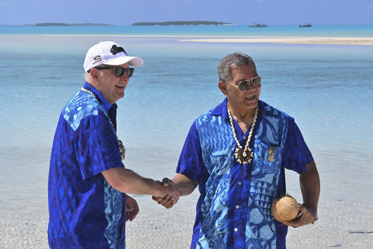 Australia's Prime Minister Anthony Albanese, left, and Tuvalu's Prime Minister Kausea Natano shake hands.