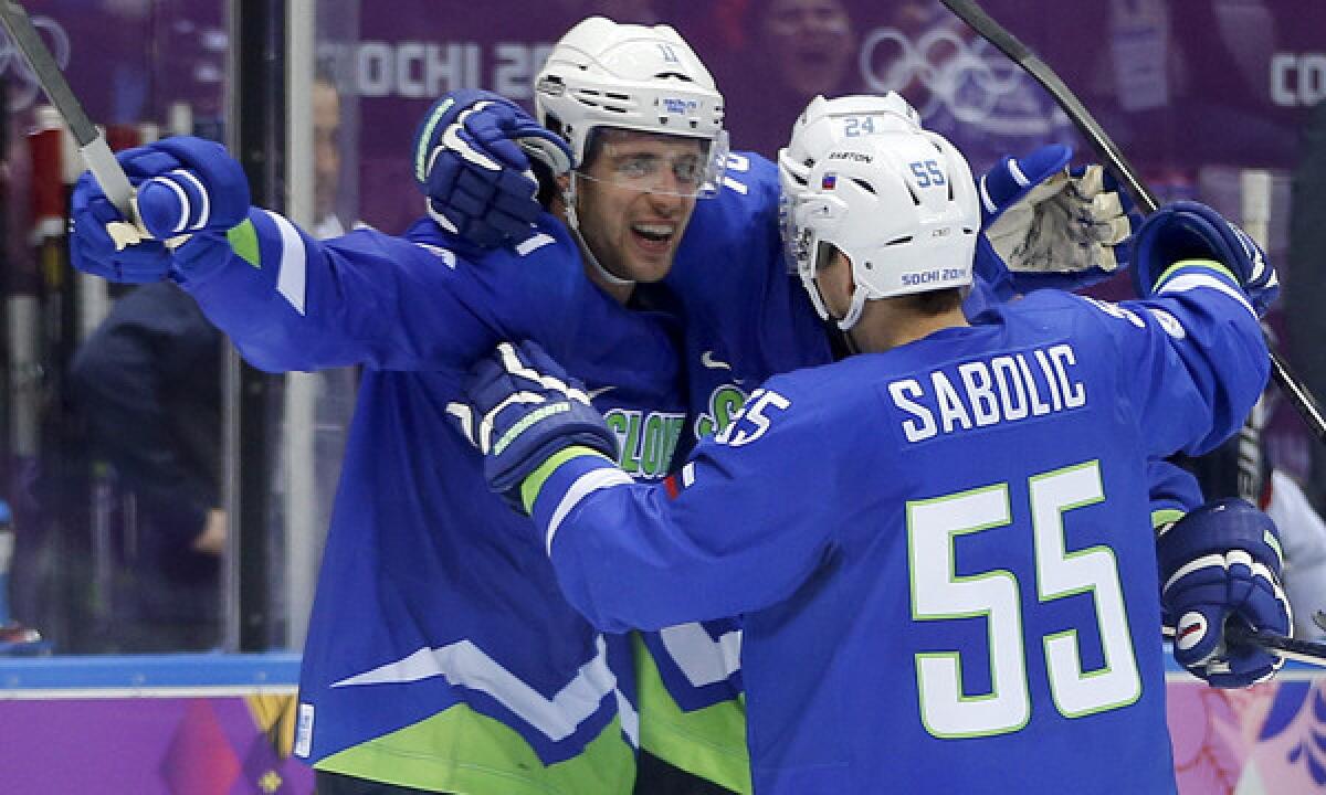 Slovenia forward Anze Kopitar, left, celebrates with teammate Robert Sabolic after scoring a third-period goal against Slovakia on Feb. 15 in the Sochi Winter Olympic Games. Kopitar said it was great being part of a solid overall effort by Slovenia in the Olympic Games.