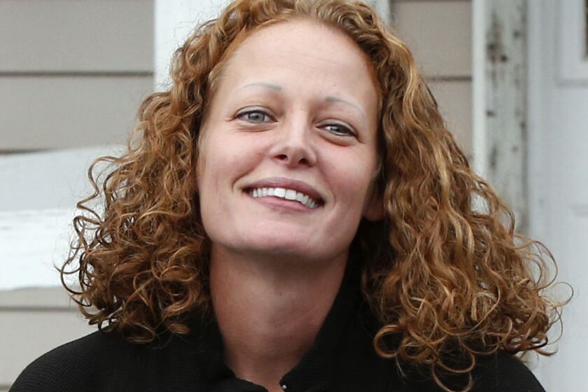 In an October 31, 2014 file photo, Kaci Hickox comes out of her house to speak to reporters, in Fort Kent, Maine. Hickox's plans for the end of the deadly disease's 21-day incubation period on Monday, Nov. 11 include a dinner out with her boyfriend, but she told The Associated Press she's worried about what type of a reception she'll get after being hailed by some and vilified by others for battling state-ordered quarantines in New Jersey and Maine.