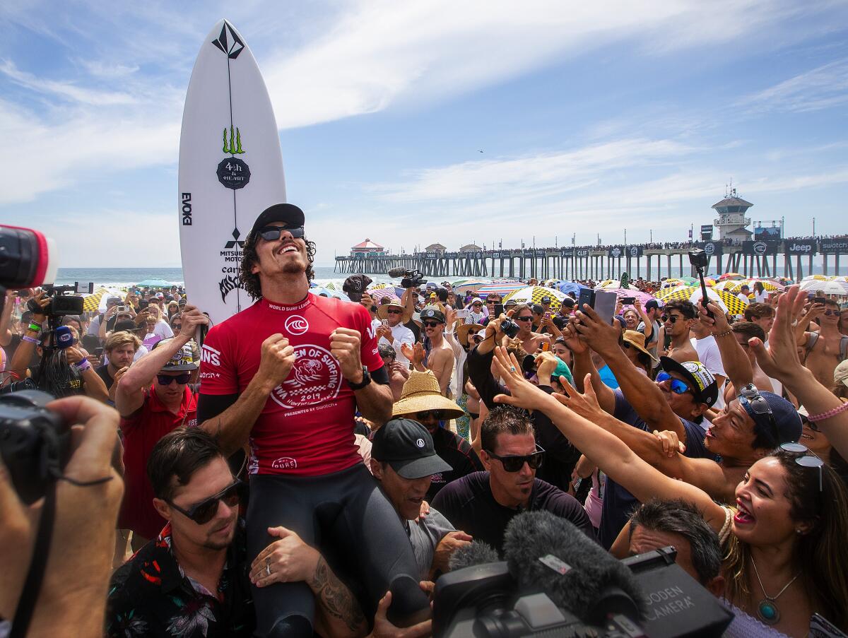 Yago Dora of Brazil celebrates with fans in Huntington Beach after winning the 2019 Vans U.S. Open of Surfing.