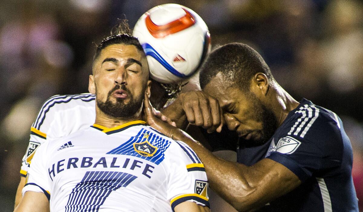 Los Angeles Galaxy midfielder Sebastian Lletget, left, and Vancouver Whitecaps defender Kendall Waston fight for a head ball during a Galaxy 1-0 loss to the Whitecaps on June 6.