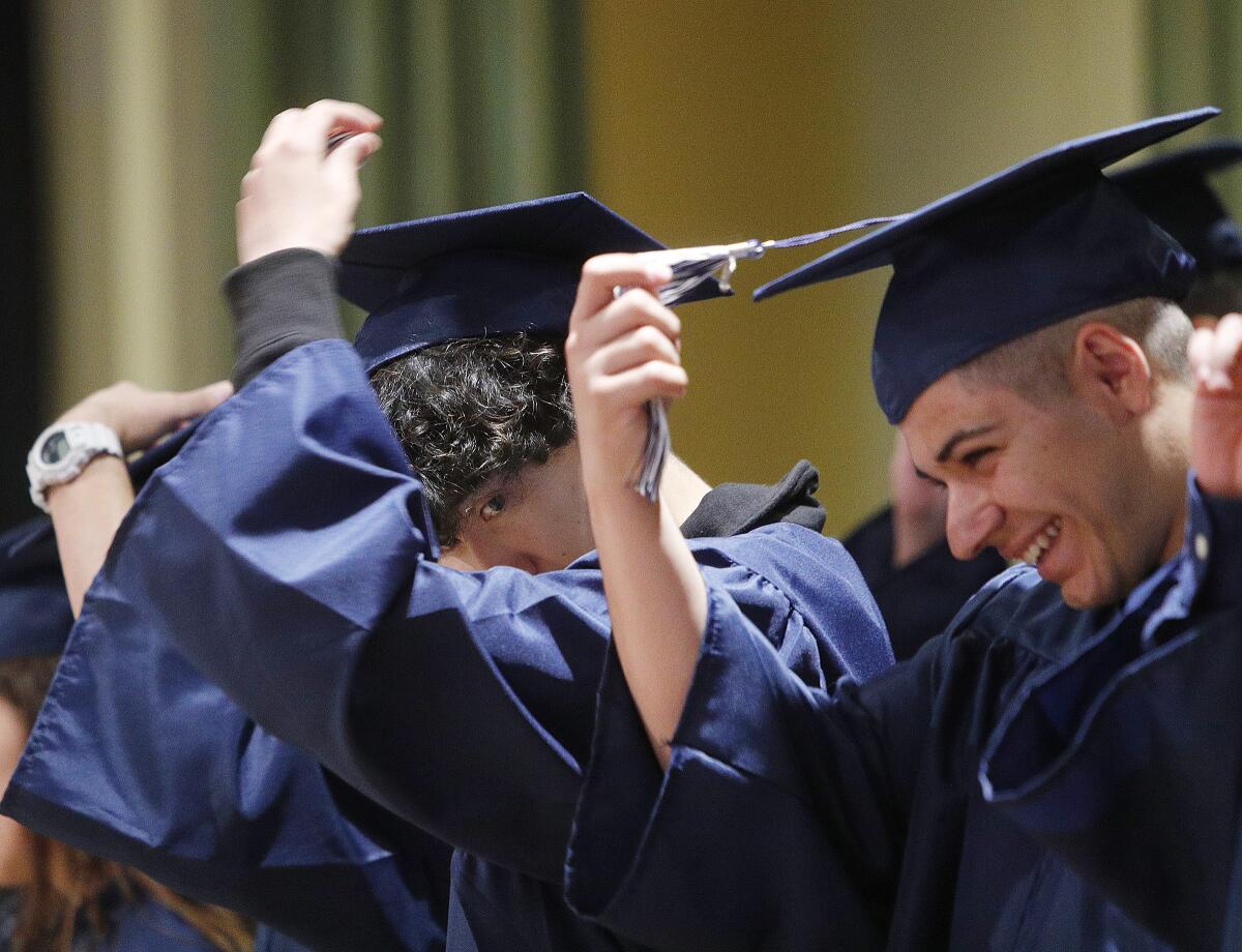 Allan F. Daily's Art Da Silva Faustino and Harutyun Karapetyan move their tassels after graduating in the Glendale Unified School District 2019 summer graduation at First United Methodist Church of Glendale in Glendale on Friday. High schools included in the graduation were Allan F. Daily, Clark Magnet, Crescenta Valley, Hoover, Glendale, and Verdugo Academy.