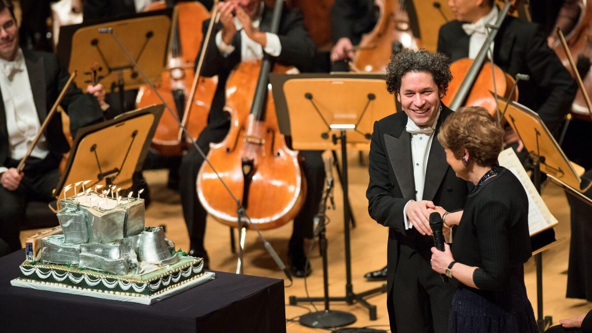L.A. Phil President and CEO Deborah Borda surprises Gustavo Dudamel with a cake for his 36th birthday.