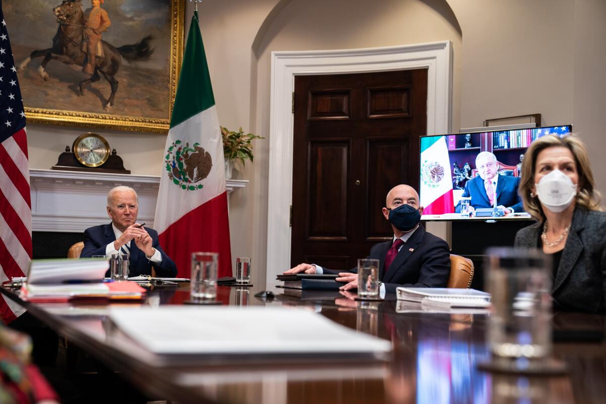 President Joe Biden and his cabinet meet with Mexican President Andrés Manuel López Obrador (on monitor). 