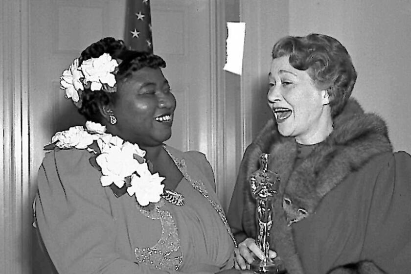 Hattie McDaniel, left, gets an Oscar in 1940 from Fay Bainter.