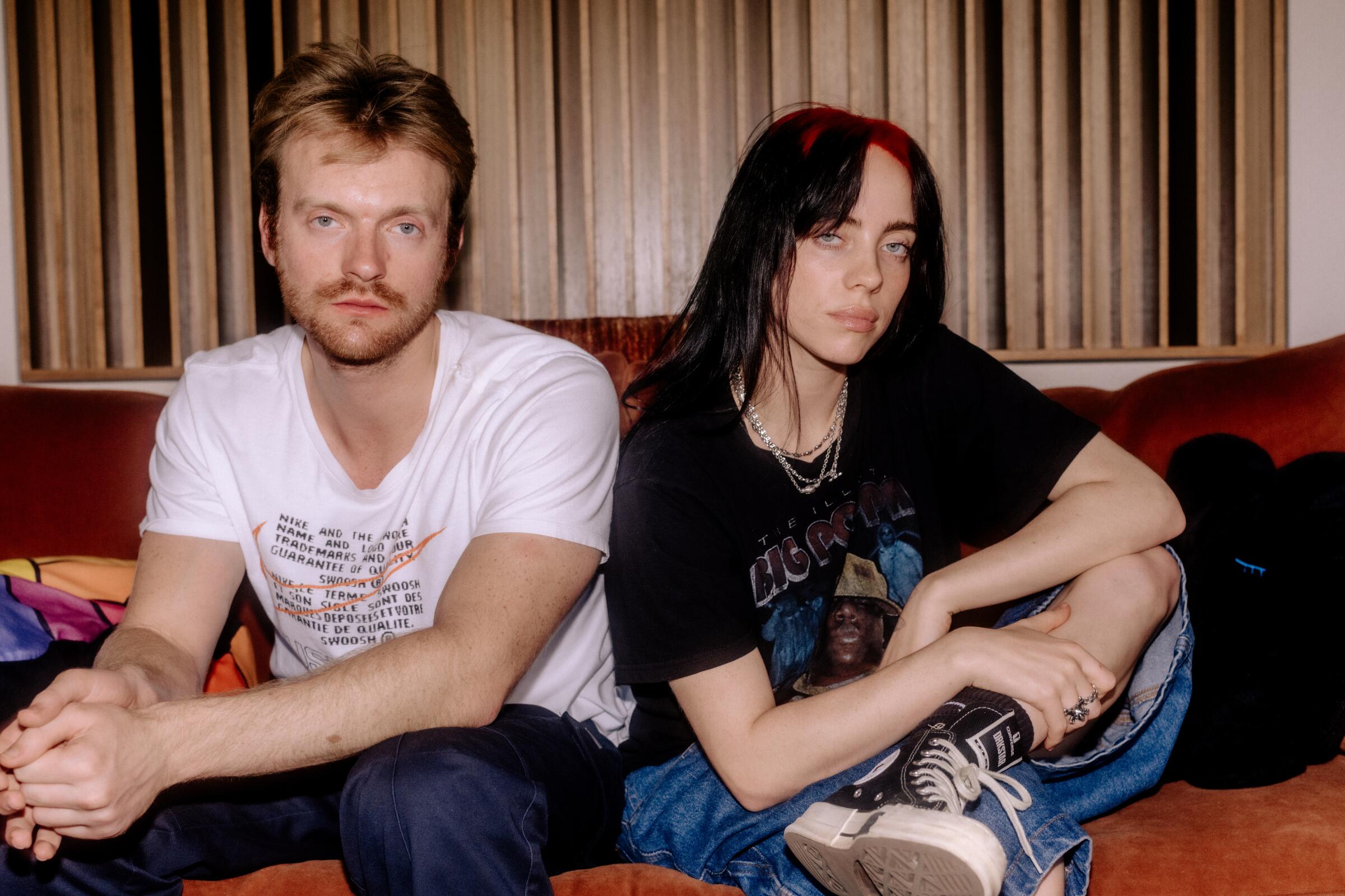 A male and female musician, seated on a sofa