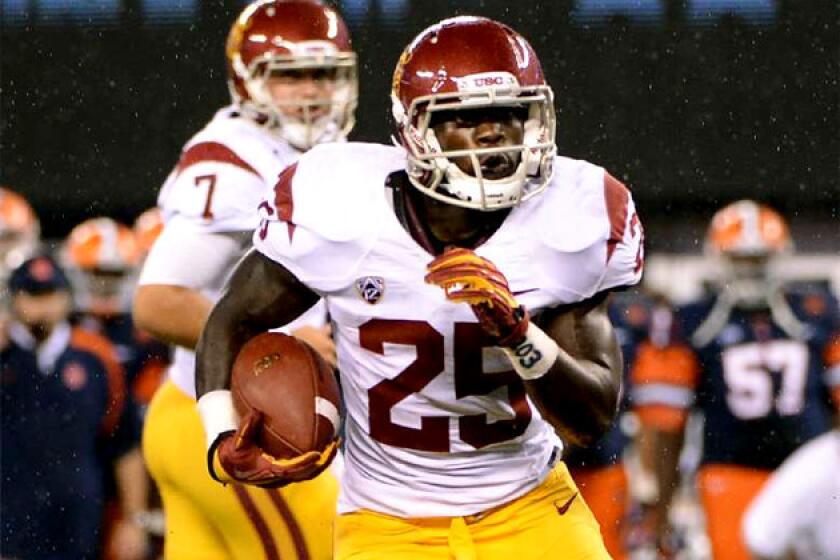 USC running back Silas Redd gets a hand off from Matt Barkley during a game against Syracuse.