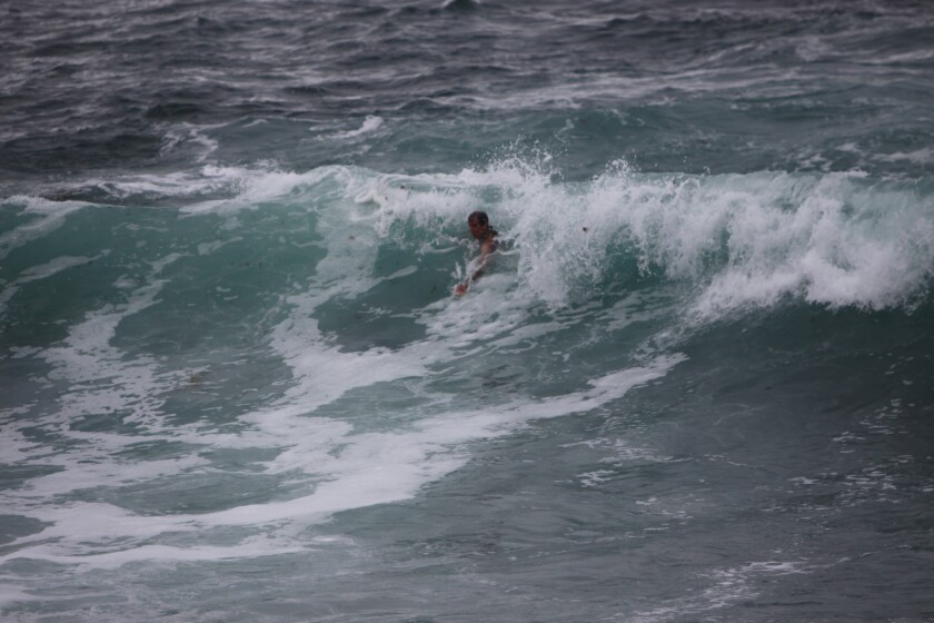 A bodysurfer catches a wave just off La Jolla's Boomer Beach.
