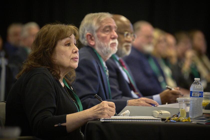 In this photo provided by UM News, United Methodist Bishop Minerva G. Carcaño, foreground, attends her church trial on Sept. 19, 2023, in Glenview, Ill. Beside her are her two counsel, the Rev. Scott Campbell and Judge Jon Gray. A United Methodist Church court acquitted Carcaño, Friday, Sept. 22, of all charges in the first trial of one of church’s bishops in nearly a century. Carcaño, the first Latina bishop in the denomination and a prominent voice on behalf of immigrants, faced four charges of violating church law. (Paul Jeffrey/UM News via AP)