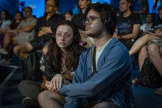 People listen to a public talk at the Ukrainian House in Paris, France, Sunday, Aug. 4, 2024. (AP Photo/Hanna Arhirova)