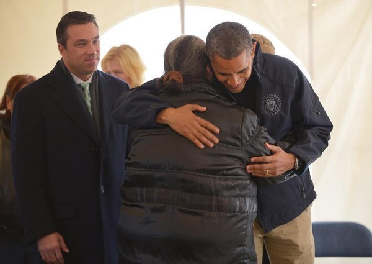 President Obama hugs a woman as he tours a FEMA disaster recovery center on Staten Island on Thursday.