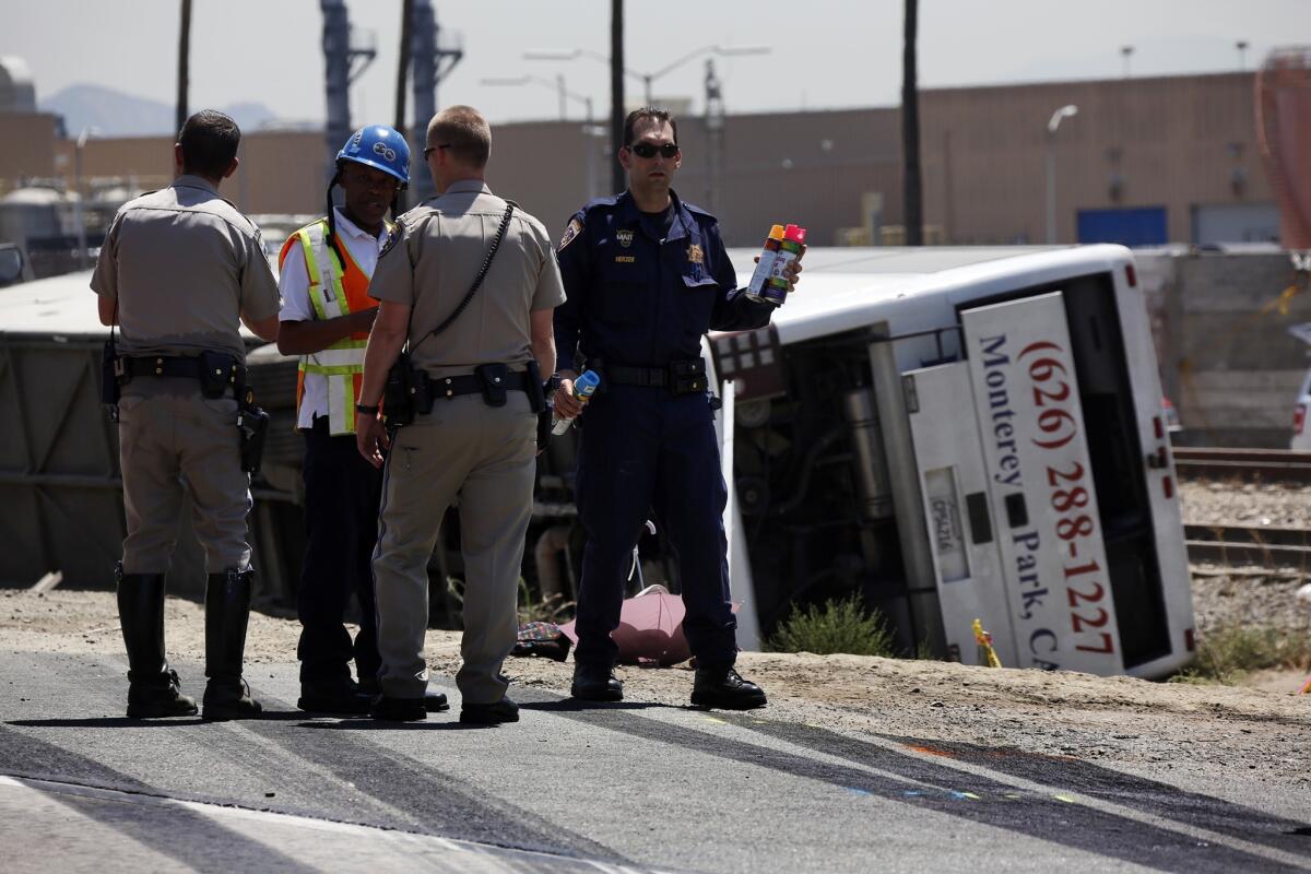 One Los Angeles-based bus company was among those shuttered by federal regulators over safety violations in a nationwide crackdown. The inspections were prompted by recent bus crashes. Above, investigators are at the scene of an overturned charter bus in Irwindale in August that injured 55.