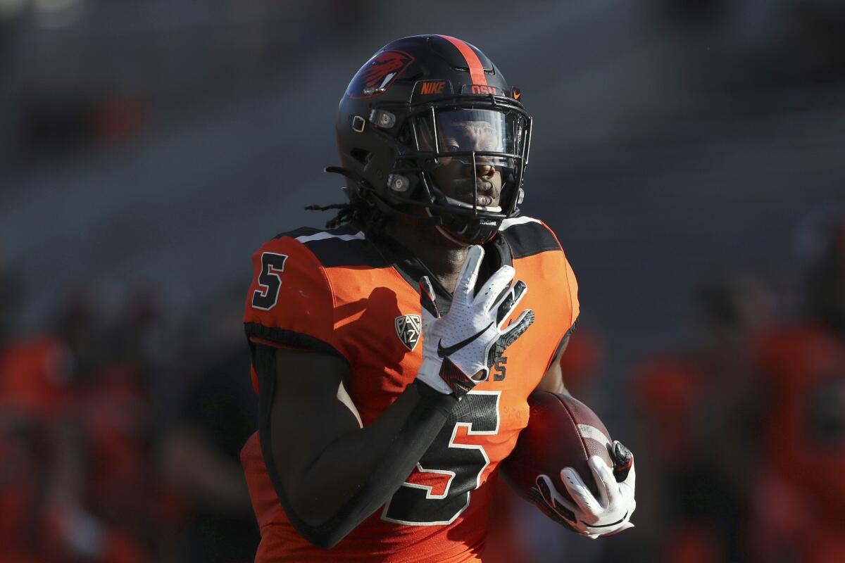 FILE - Oregon State running back Deshaun Fenwick (5) warms up prior to an NCAA college football game against Washington on Oct. 2, 2021, in Corvallis, Ore. The Beavers open the season against a pair of Mountain West opponents. (AP Photo/Amanda Loman, File)