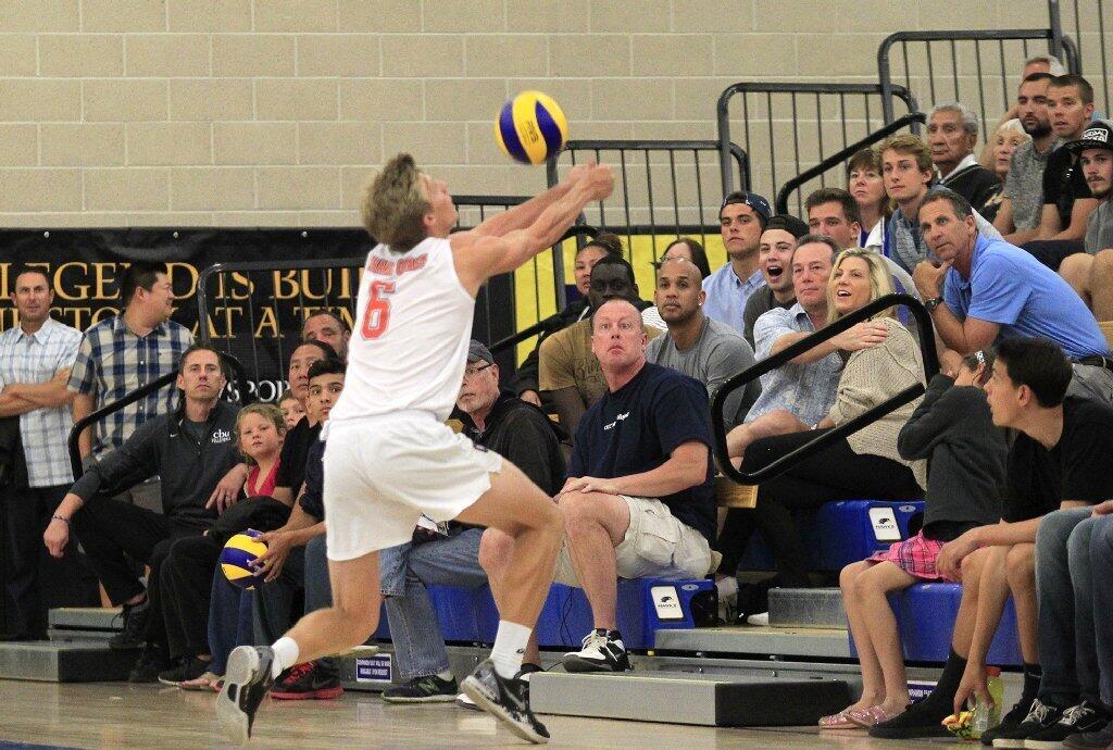 Fans look on as Orange Coast College's Ty Hutchins (6) keeps the ball alive against Santa Monica in the 2014 California Community College Athletic Assn. State Championship match at Santiago Canyon College in Orange on Friday.