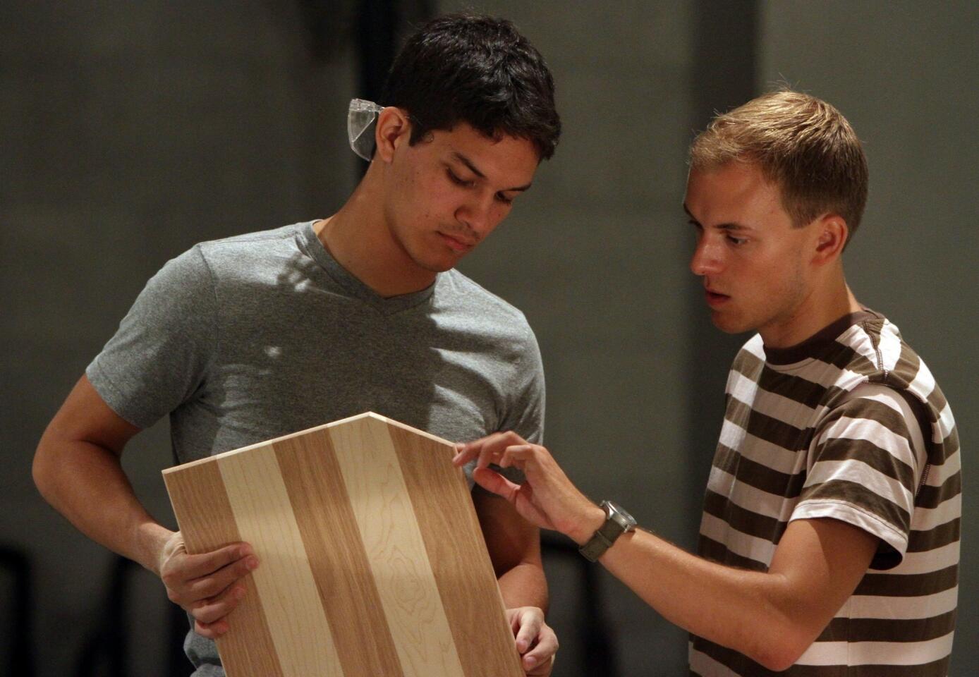 Would-Works co-founder Connor Johnson, right, talks with artisan Diego Gonzalez of Hollywood on a recent Saturday at the Central City Community Outreach Center on skid row in Los Angeles. Participants create cutting boards as part of an enterprise designed to encourage self-sufficiency and promote craft.