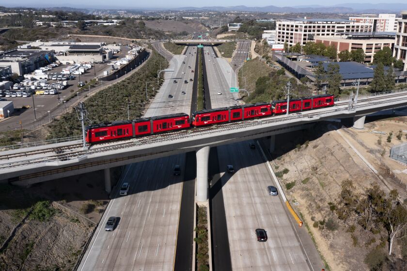 SAN DIEGO, CA - NOVEMBER 21: The Mid-Coast Extension of the UC San Diego Blue Line Trolley crosses I-5 on Sunday, Nov. 21, 2021 in San Diego, CA. (K.C. Alfred / The San Diego Union-Tribune)