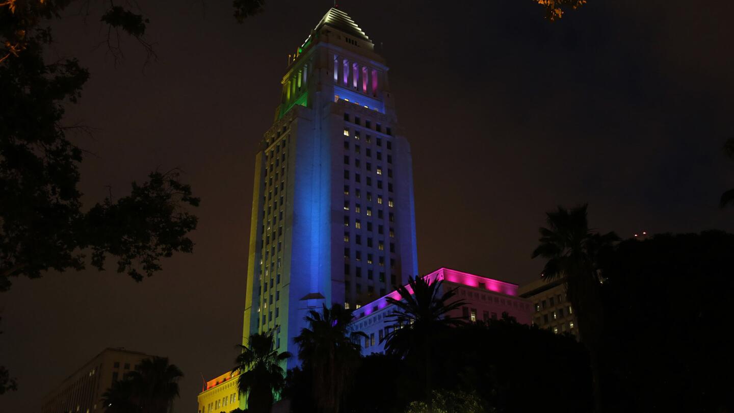 City Hall is lit up in colors of the rainbow during a candlelight vigil and rally, hosted by the Los Angeles LGBT Center, at Los Angeles City Hall, for the victims of Sunday's massacre at a gay nightclub in Orlando.