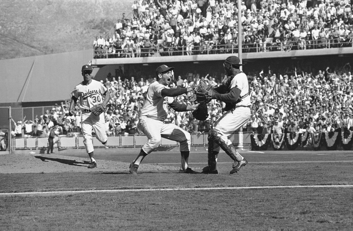 Baseball players whoop it up on the playing field.