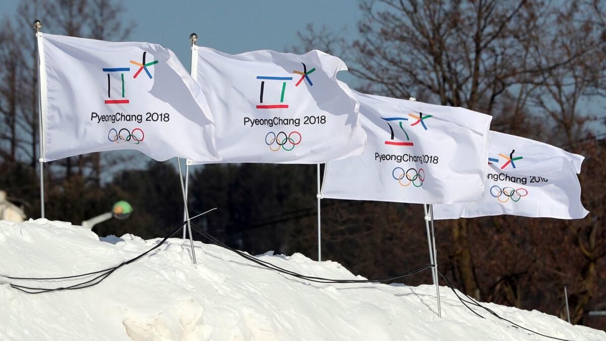 Flags with the emblems of the 2018 Winter Games flutter in Pyeongchang, South Korea.