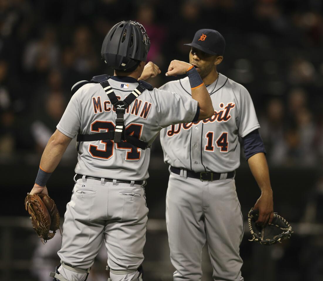 Tigers starting pitcher David Price, flexing biceps with catcher James McCann, after the last out of his complete game.