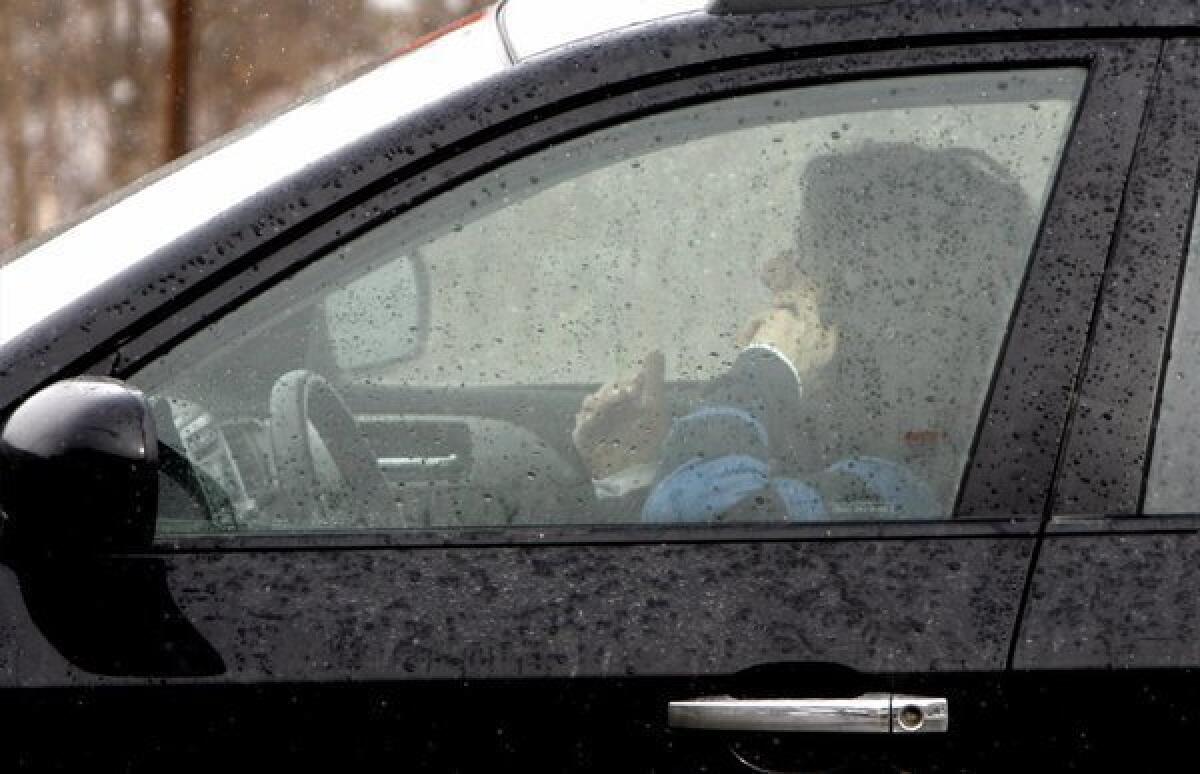A motorist on a cellphone, a common scene on U.S. streets.