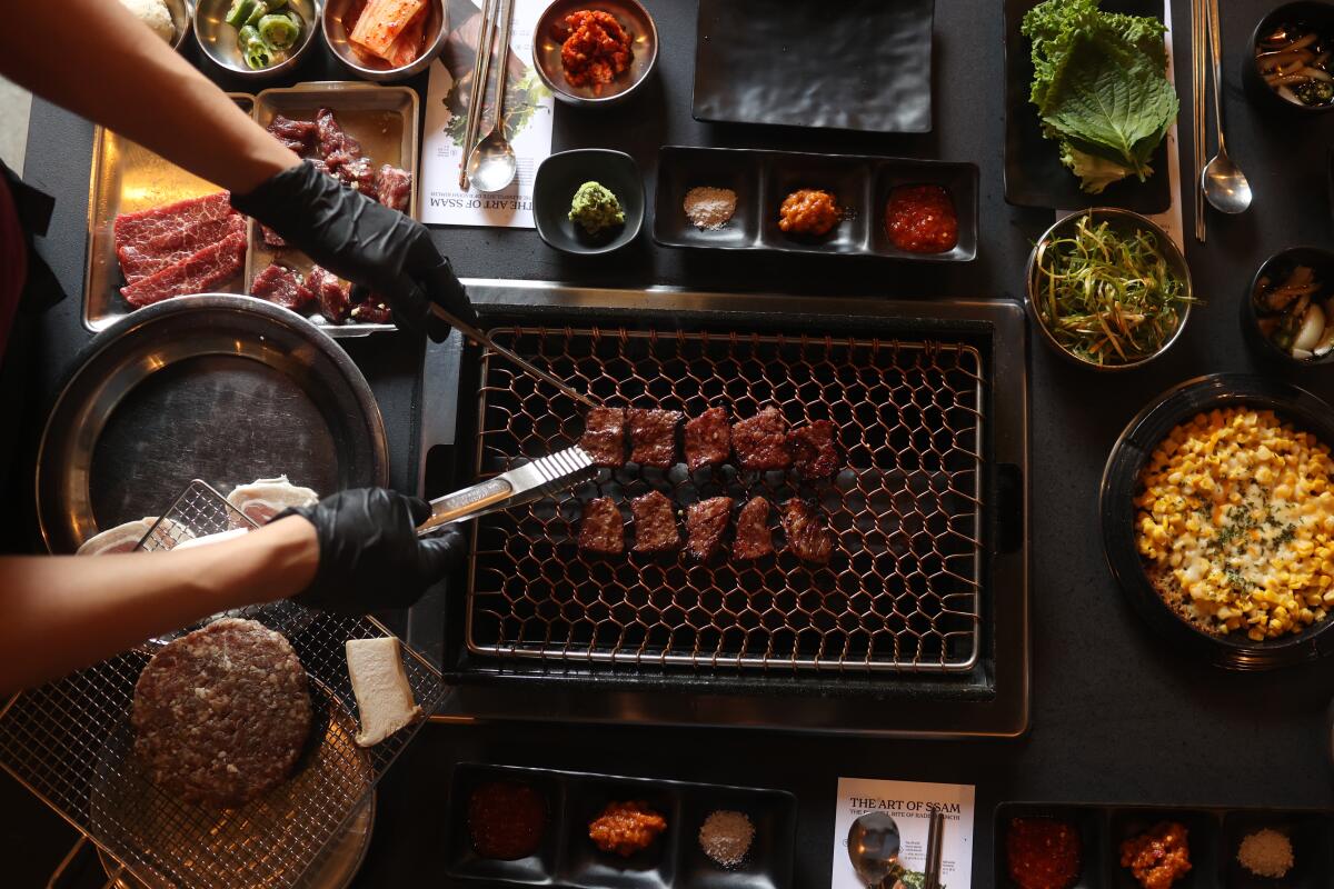 Simon Sung cooks Korean beef alongside other dishes at Origin, a recently opened barbecue restaurant in Koreatown.