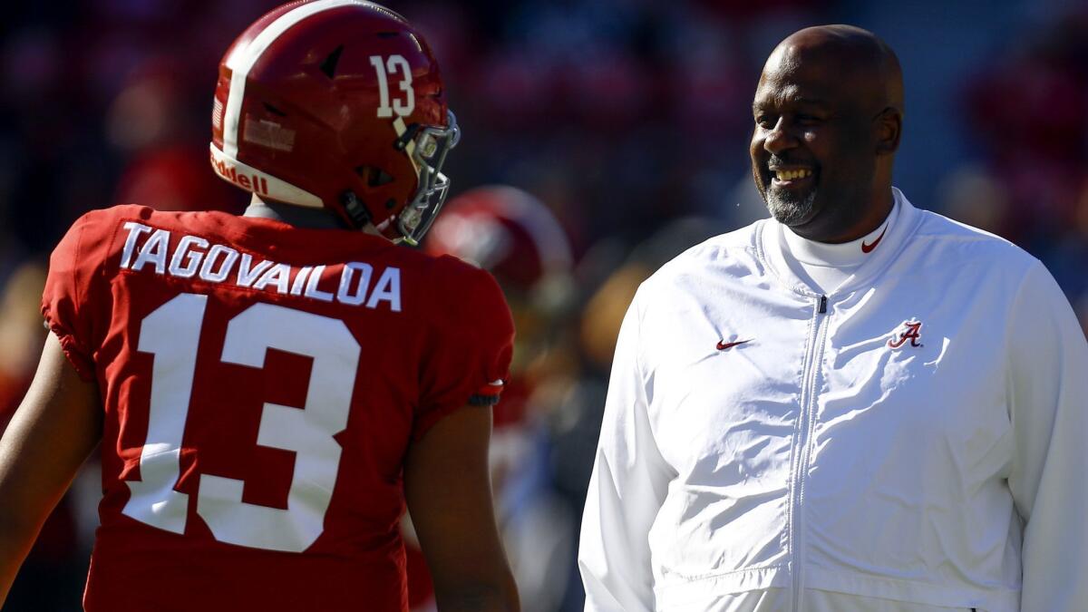 Alabama quarterback Tua Tagovailoa talks with Alabama offensive coordinator Mike Locksley before the start of a game on Nov. 10.