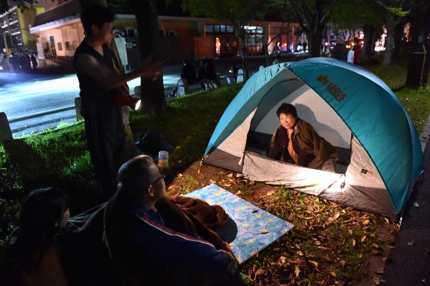 Evacuated residents wait at a park in Kumamoto city April 16 after another strong earthquake shook Japan.